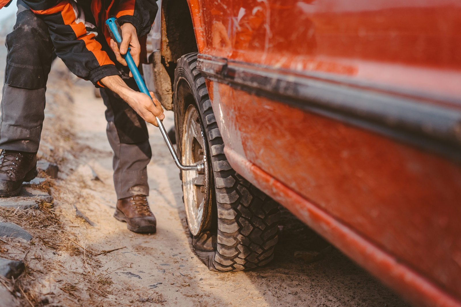 man-unscrews-bolts-wheel